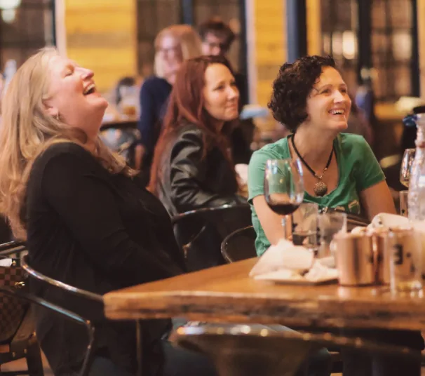 Audience members laughing together at a People Tree show